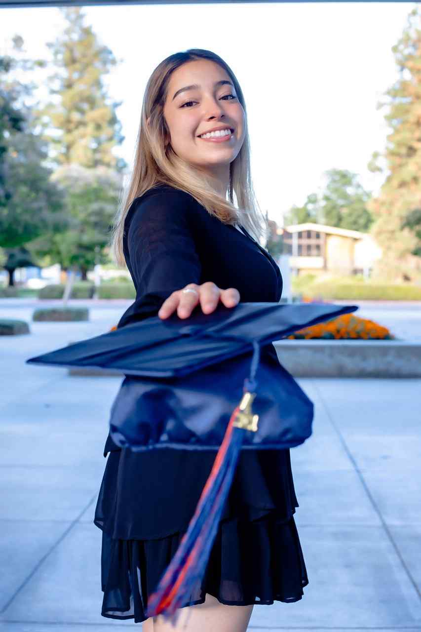 Smiling college graduate holding a graduation cap while exploring Federal Education Loans, comparing Student Loan Interest Rates Refinance options, researching Top Student Loan Refinance programs, considering how to Refinance Student Loans with Cosigner, and evaluating opportunities to Refinance Student Loans with Bad Credit.