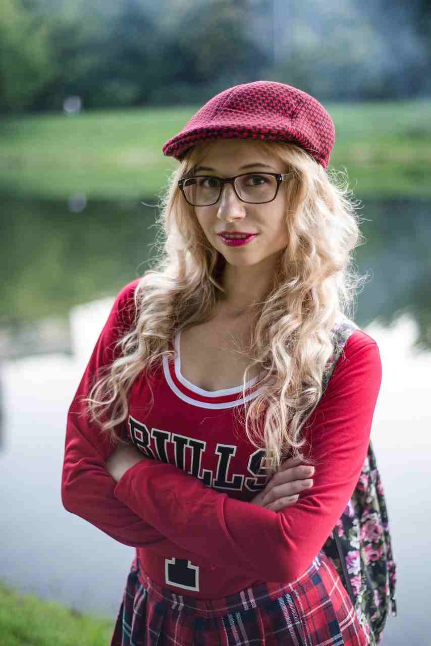Young student standing outdoors near a lake wearing glasses and a red outfit while researching Student Loans, reviewing Truth in Lending disclosures, comparing Subsidized vs Unsubsidized Student Loans, exploring Forgiving Student Loans programs, and learning about Student Loans Without a Cosigner.