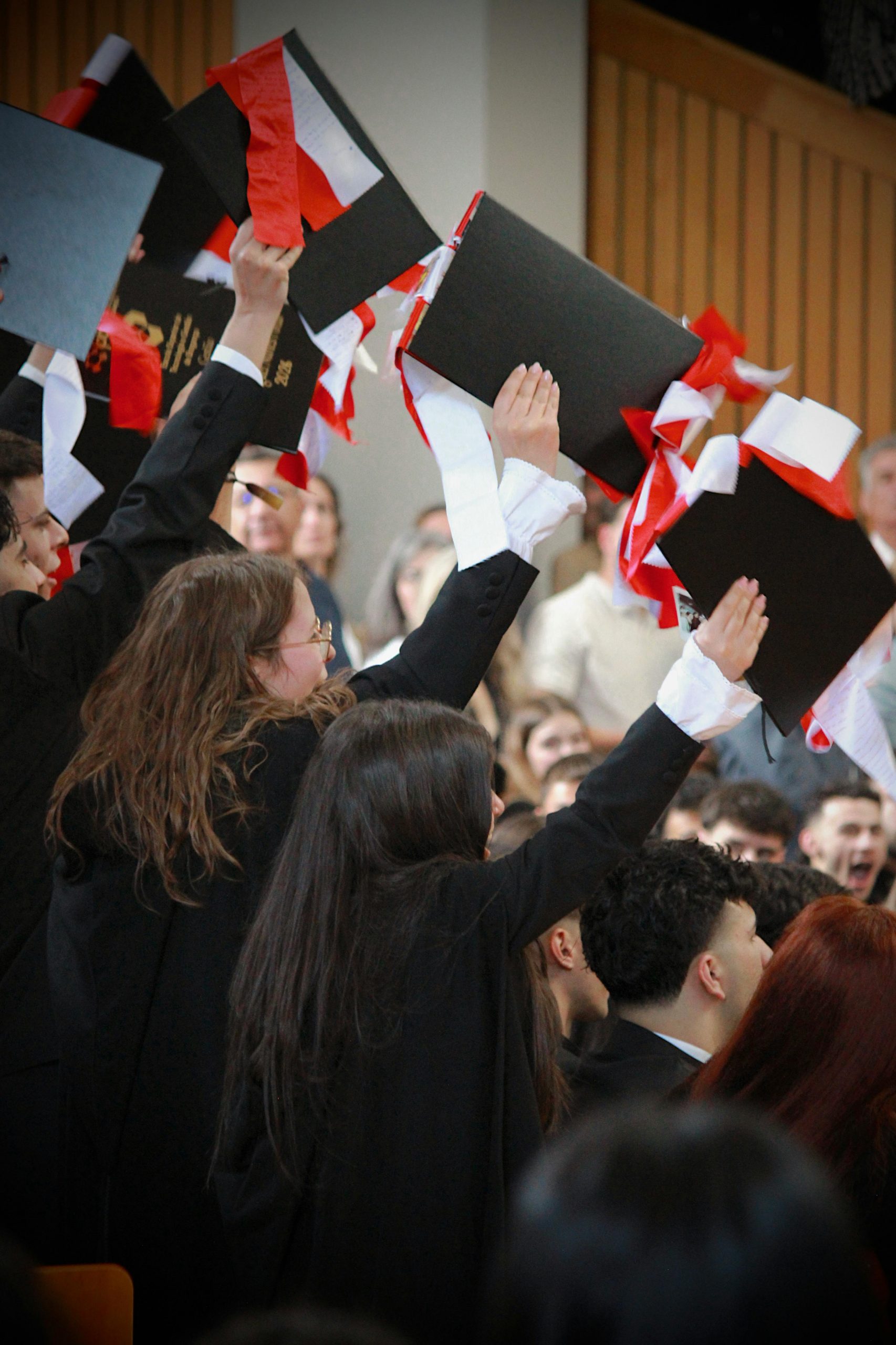 Graduates celebrating with diplomas raised during a commencement ceremony while reviewing a Student Loan Refinance Calculator, comparing Student Loan Refinance Terms, learning When to Refinance Student Loans, asking Should I Refinance my Student Loans, and accessing important information through the Privacy Policy page.