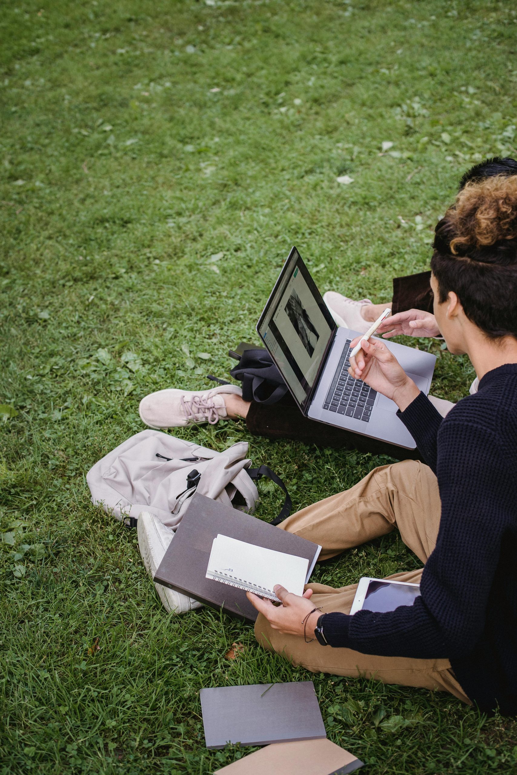 College students studying outdoors with laptops and notebooks while researching Student Refinance options, learning How to Refinance Private Student Loans, comparing Student Loan Rates Refinance programs, asking How can I Refinance My Student Loans, and reviewing fafsa student loans information to better manage education costs after graduation.