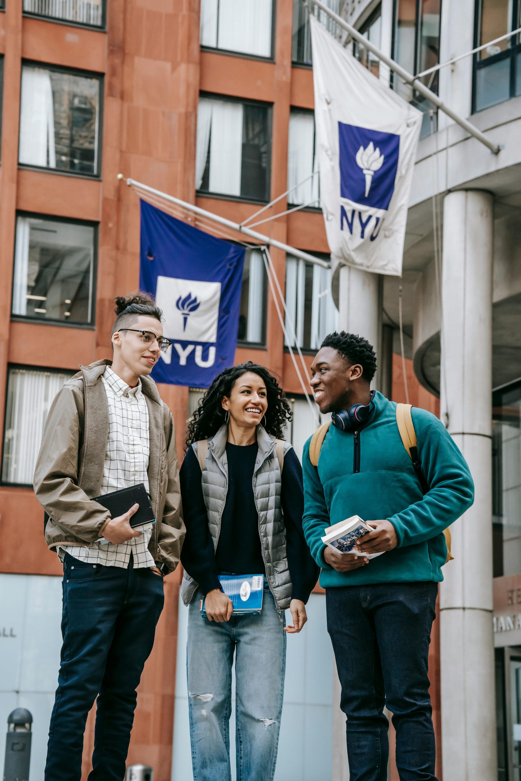 College students walking on campus discussing education financing options, including Student Loan Refinance Companies, how to Compare Student Loan Refinance Lenders, opportunities to Refinance Student Loans, whether Can You Refinance Private Student Loans, and strategies for Student Loans Refinance after graduation.