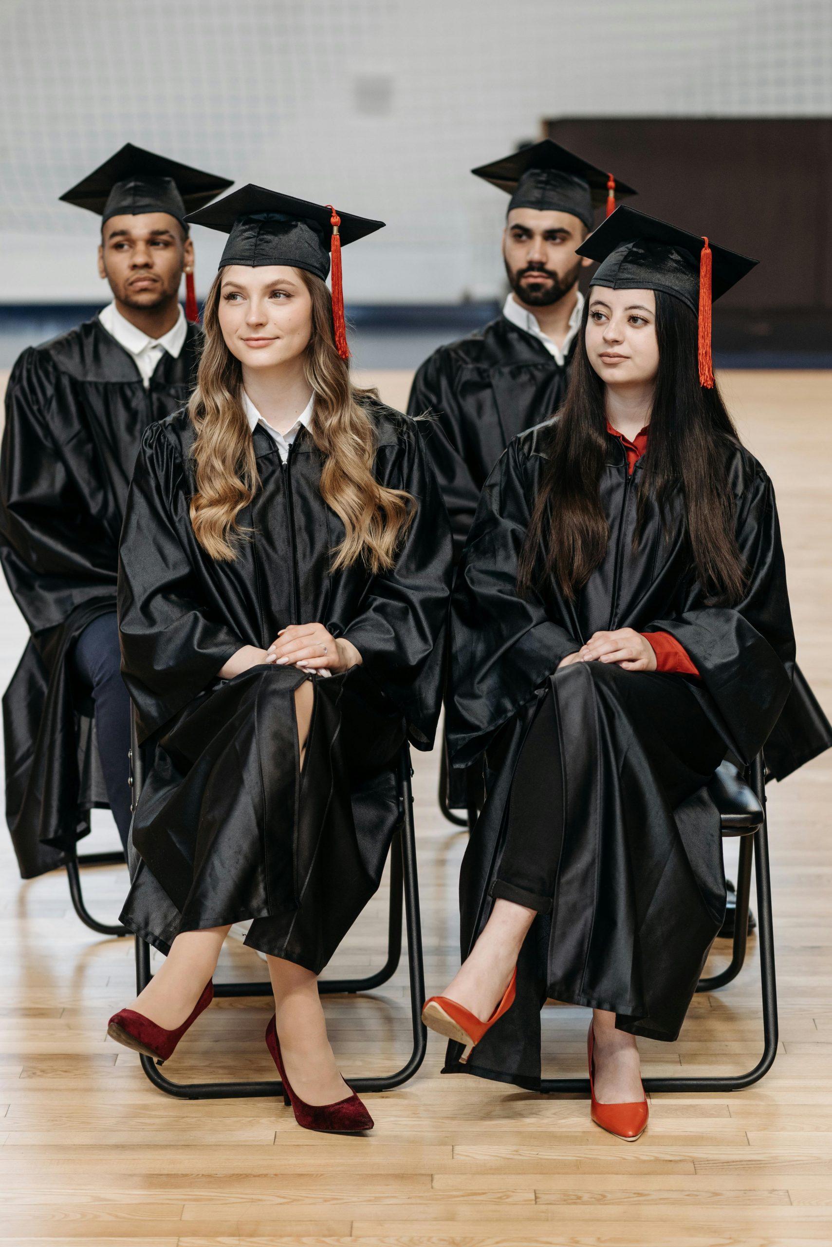 Graduating students seated during a commencement ceremony while exploring options to Refinance Federal Student Loans to Private lenders, planning for Repaying Student Loans, researching Student Loans for Community College, evaluating how to Refinance Student Loans after Graduation, and asking When should I Refinance Student Loans to potentially lower borrowing costs.